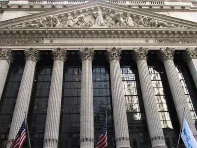 The columned neoclassical front of the New York Stock Exchange at 11 Wall Street in Lower Manhattan with flags below the pediment, photographed on 17 May 2012, a file photograph of the exchange building and not of Thursday's trading