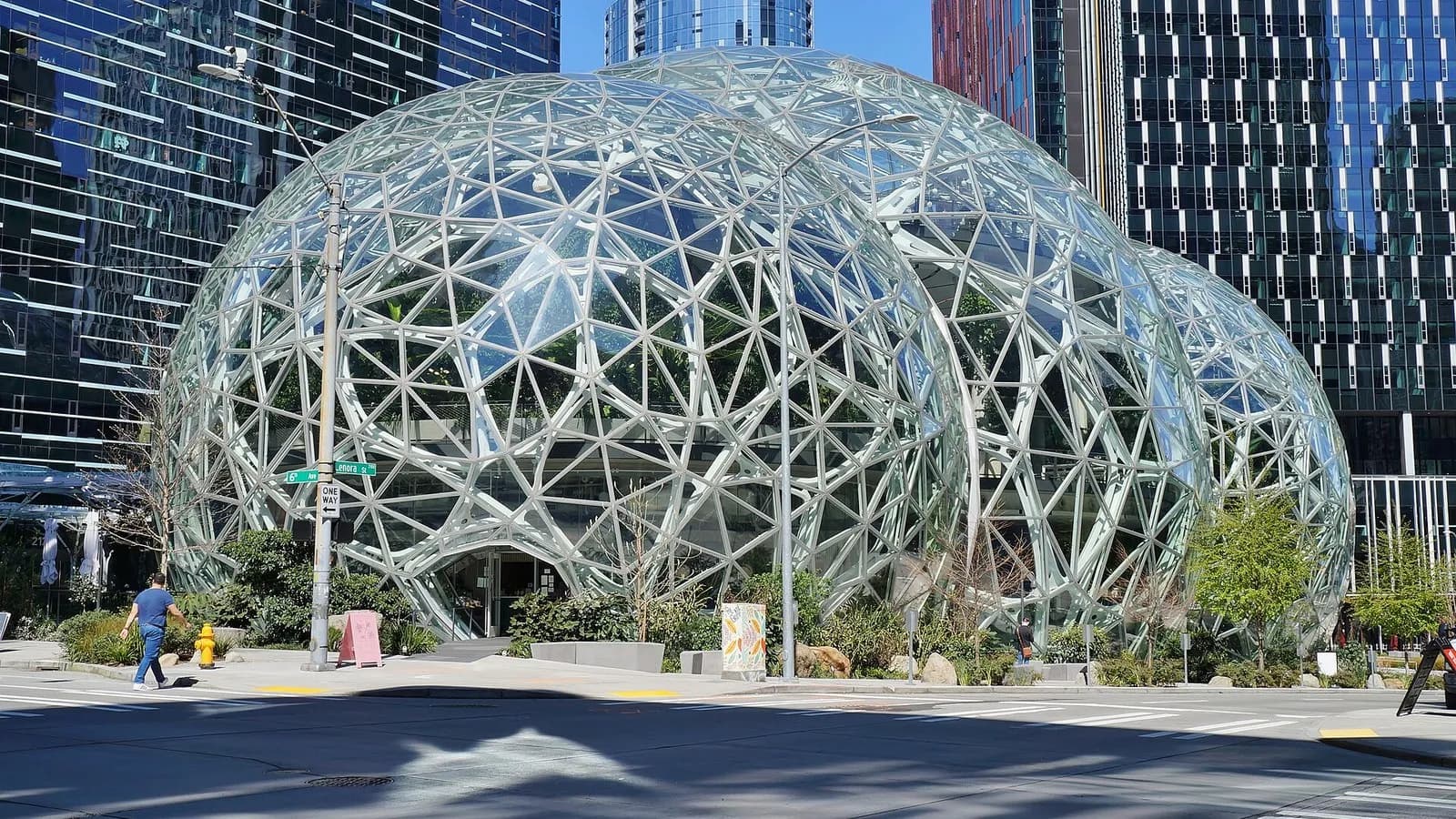 The glass and steel Amazon Spheres conservatories among office towers on the Amazon headquarters campus in Seattle, seen from 6th Avenue with pedestrians on the pavement, photographed on 9 April 2020, a file photograph of the company's campus and not of the earnings report