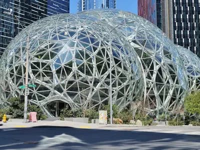 The glass and steel Amazon Spheres conservatories among office towers on the Amazon headquarters campus in Seattle, seen from 6th Avenue with pedestrians on the pavement, photographed on 9 April 2020, a file photograph of the company's campus and not of the earnings report