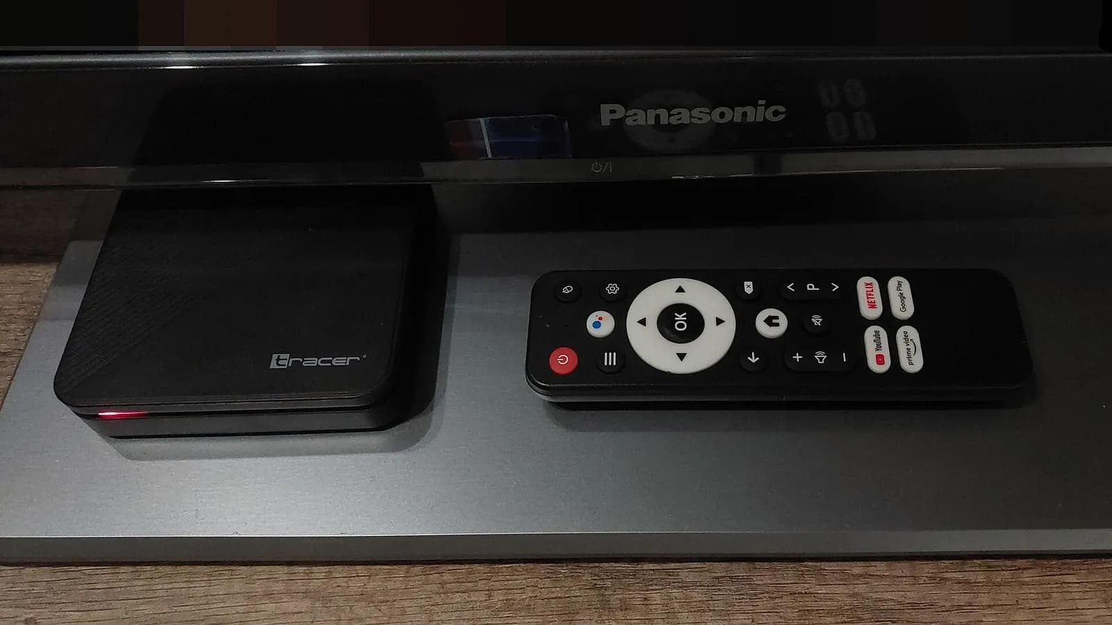 An Android TV set top box and its remote control on a shelf in front of a Panasonic television, photographed in November 2025, a file photograph illustrative of the cheap connected devices the researchers describe and not of any device in the experiments