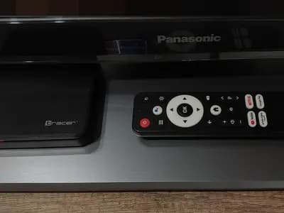 An Android TV set top box and its remote control on a shelf in front of a Panasonic television, photographed in November 2025, a file photograph illustrative of the cheap connected devices the researchers describe and not of any device in the experiments