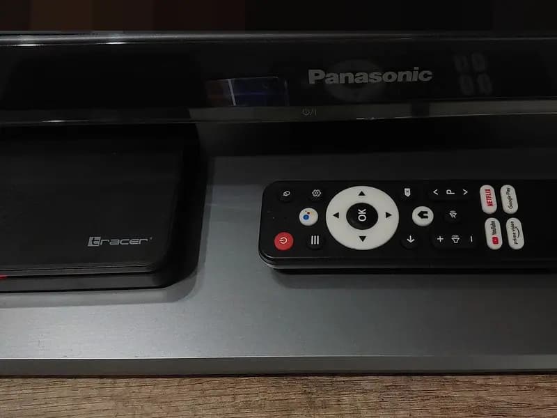 An Android TV set top box and its remote control on a shelf in front of a Panasonic television, photographed in November 2025, a file photograph illustrative of the cheap connected devices the researchers describe and not of any device in the experiments