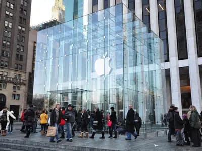 The glass cube of Apple's Fifth Avenue store in New York, with shoppers on the plaza in front of it