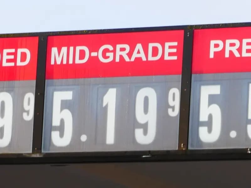 A petrol station price board in the United States showing regular, mid-grade and premium prices, photographed in April; the gasoline index has risen 27 per cent in a year