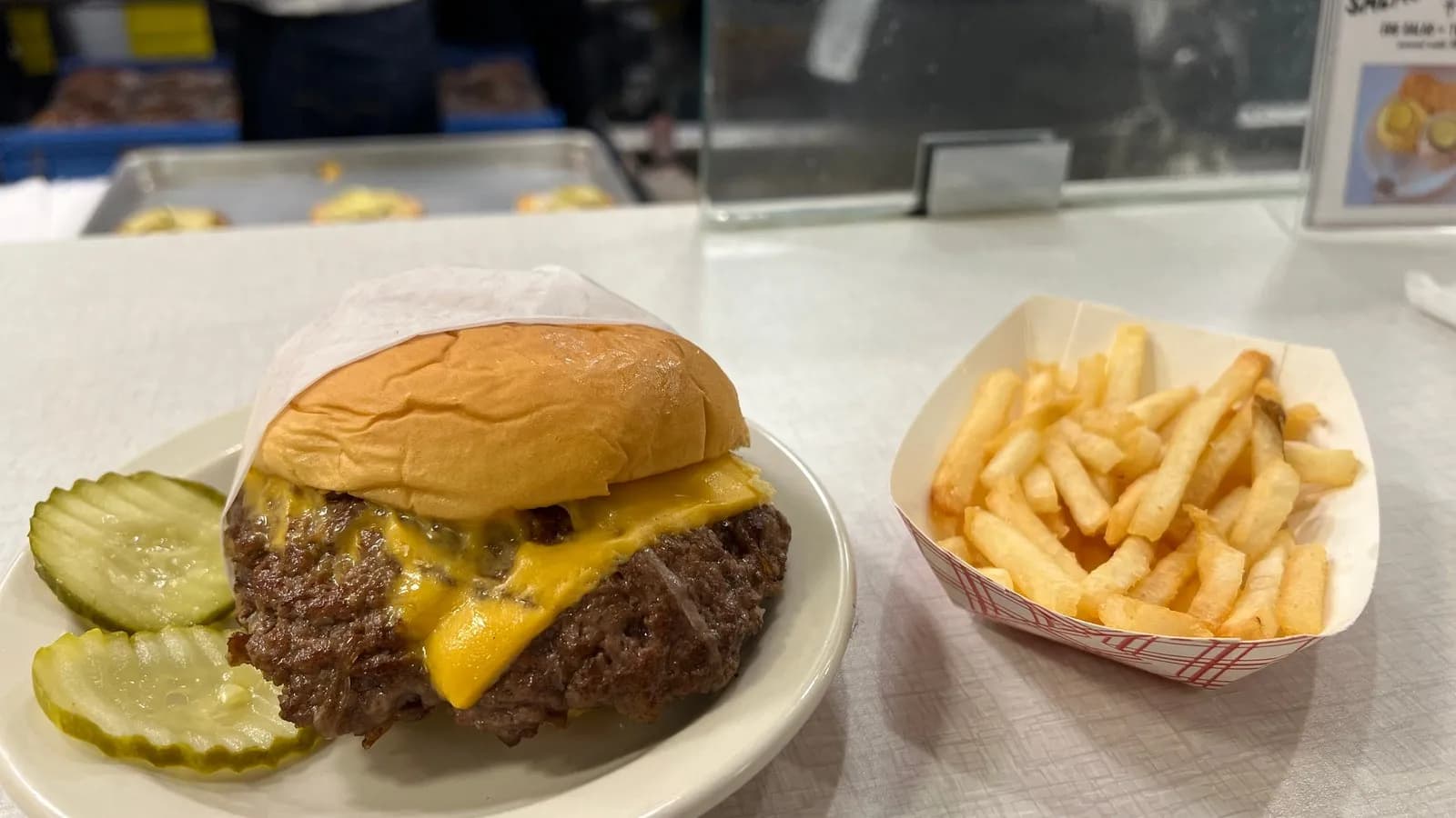A hamburger and French fries, illustrative of the fast food chains covered and not a specific chain's own product, photographed in March 2024