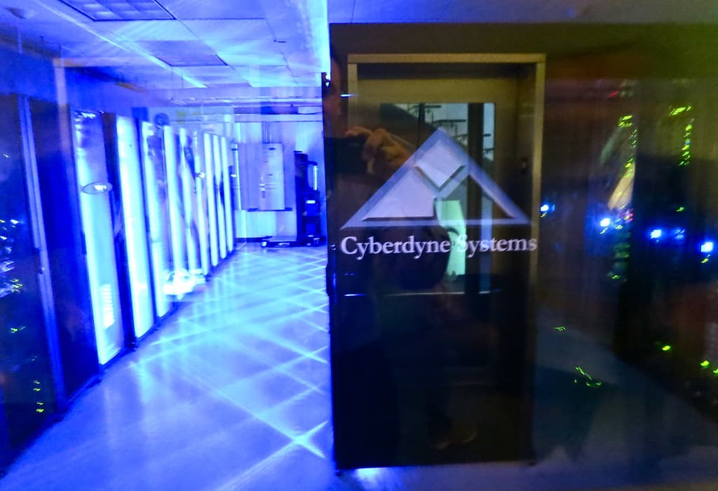 Rows of illuminated server racks in a data center, evoking the cloud infrastructure behind the outage