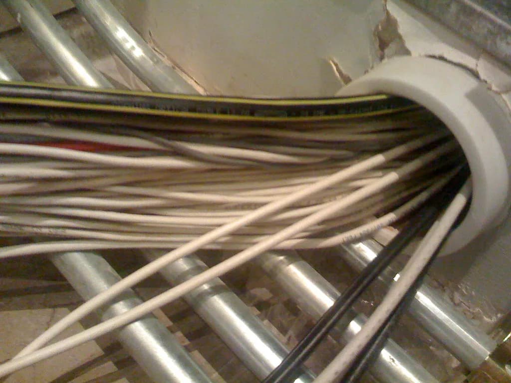 Close-up of tangled fiber optic cabling inside a data center, symbolizing internet infrastructure concentration