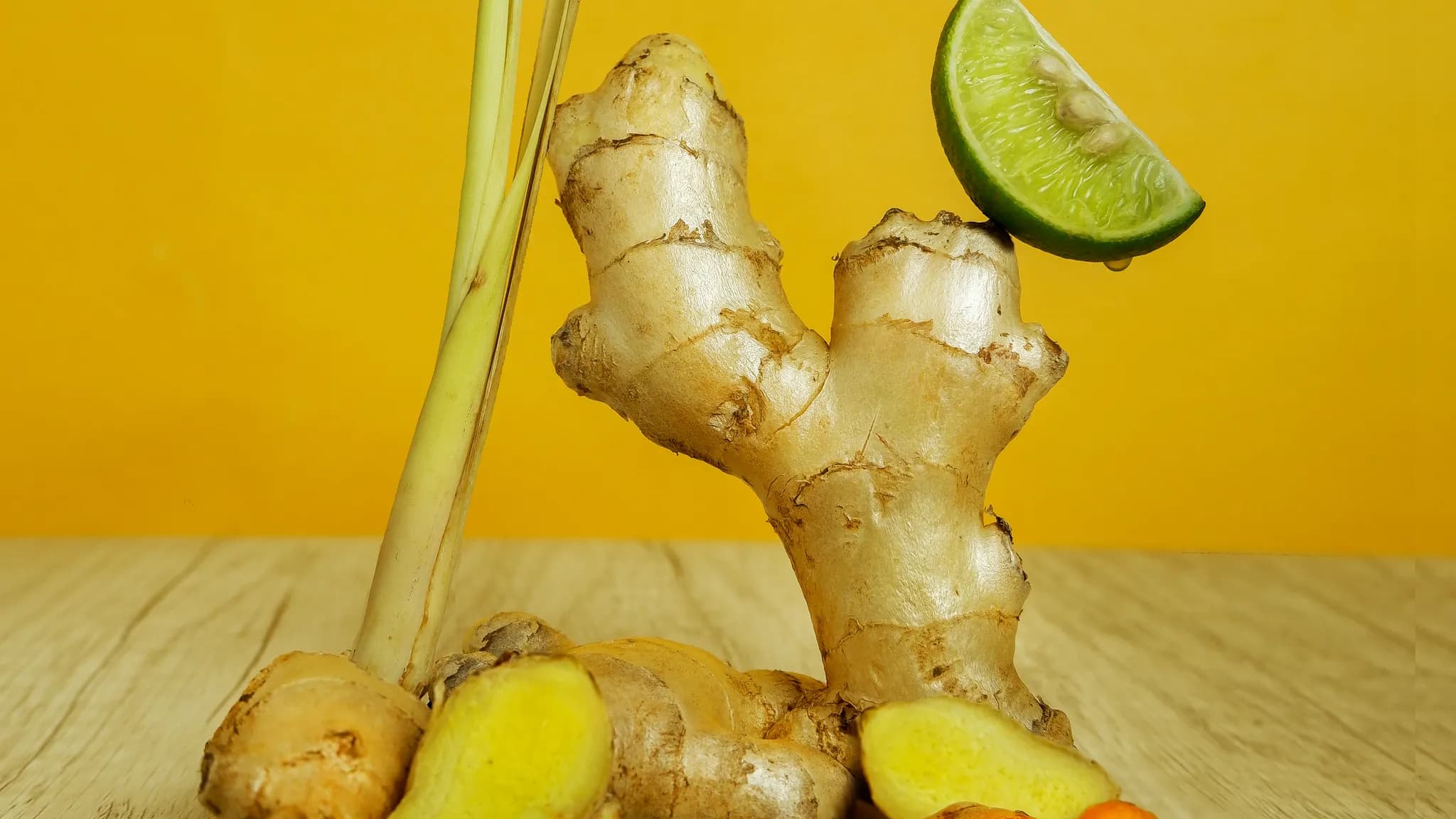 Close-up of yellow berberine supplement capsules spilled on a wooden table next to a glass of water