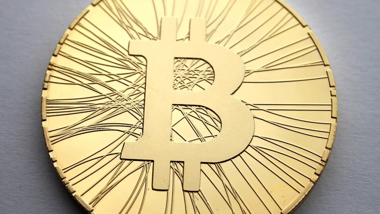 A close-up of a gold-coloured physical bitcoin collector coin on a grey surface, photographed in October 2013, a file photograph illustrative of bitcoin and not of the exchange-traded funds