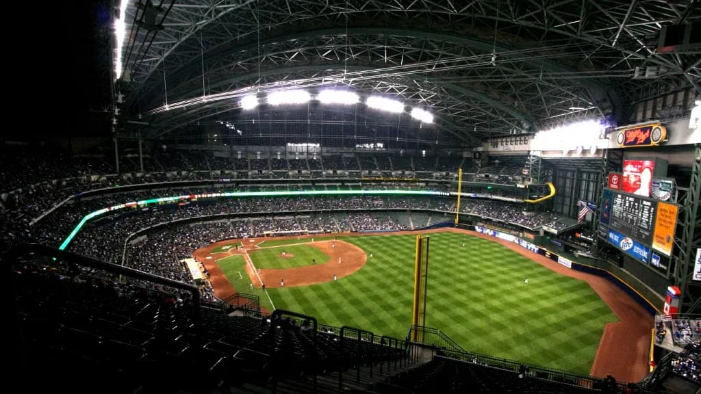 The retractable-roof ballpark in Milwaukee, then called Miller Park, lit at night with its green field, red infield dirt and a full upper deck, photographed on 13 April 2009, a file photograph of the Brewers' home ballpark and not of Wednesday's Game 5 in St. Petersburg