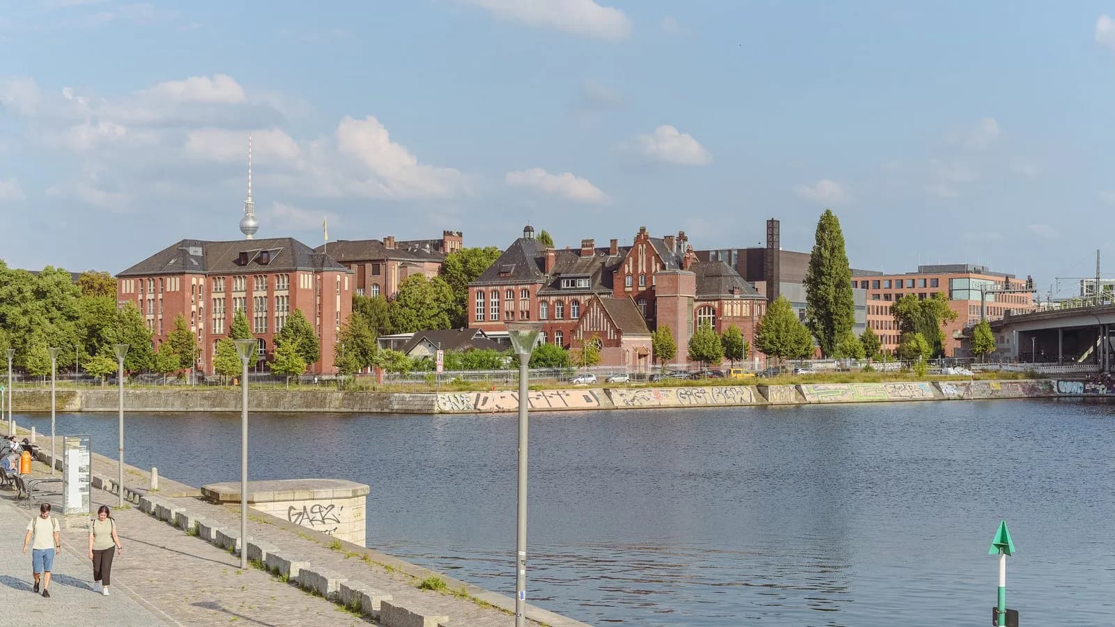 The red brick buildings of Campus Charite Mitte in Berlin seen across the Humboldthafen, photographed in 2024