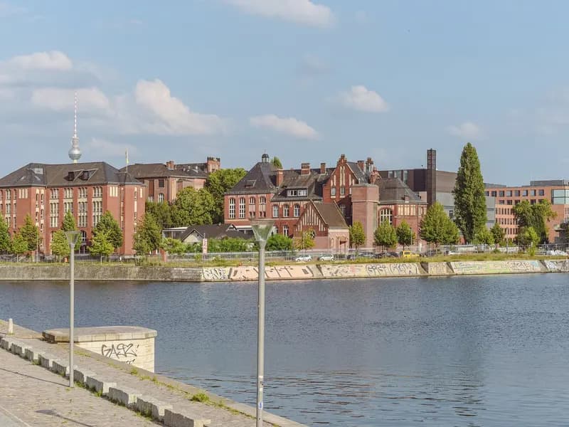 The red brick buildings of Campus Charite Mitte in Berlin seen across the Humboldthafen, photographed in 2024