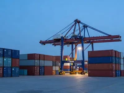 A container port terminal with a gantry crane at dusk