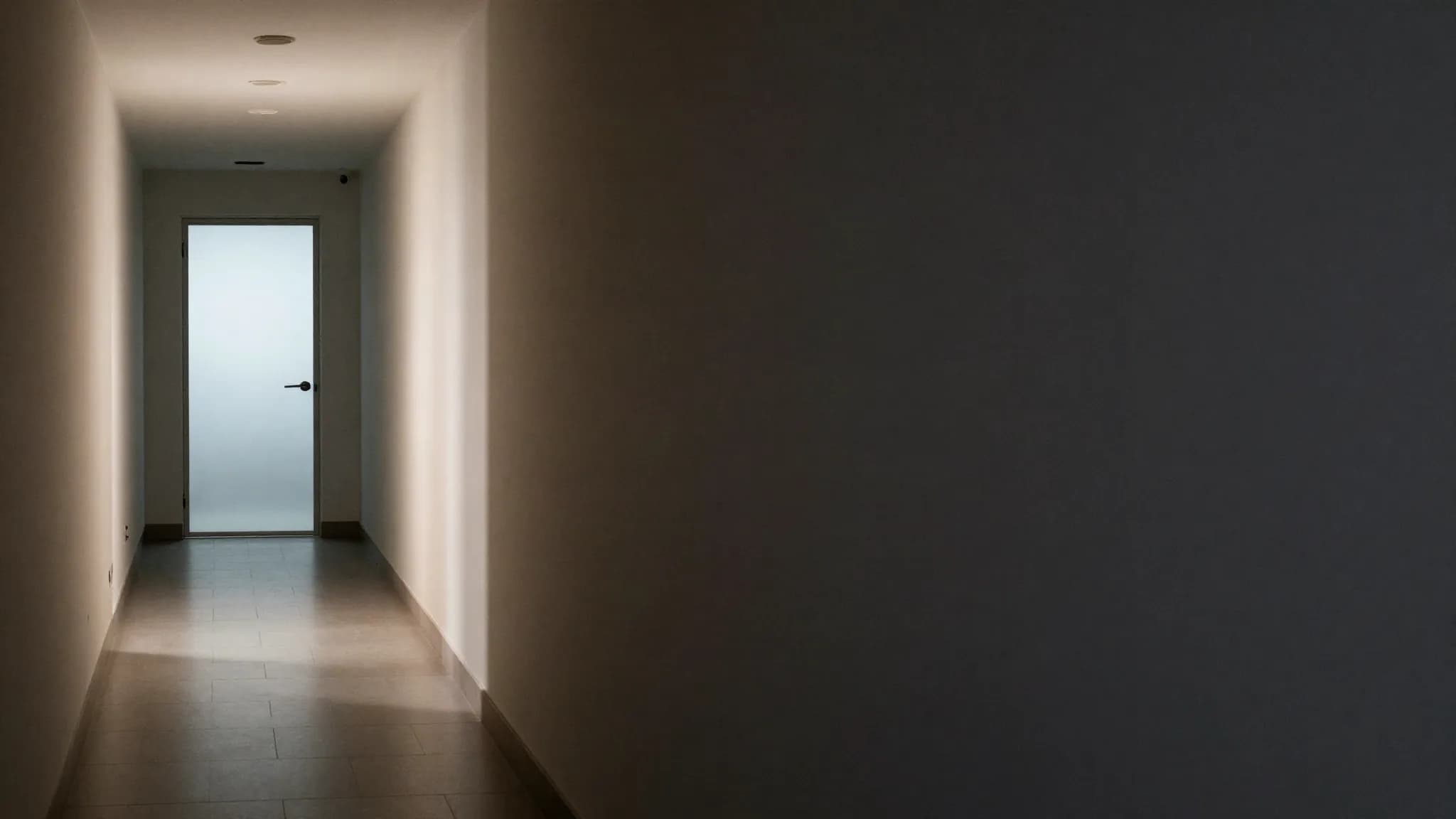 A corridor divided between light and shadow