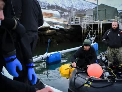 Divers in drysuits preparing on a snowy jetty in northern Norway, in a US Army photograph from March 2020
