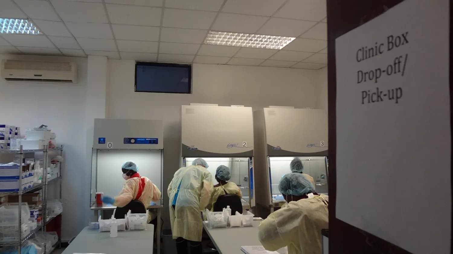 Pharmacists in protective gear prepare doses of an Ebola vaccine during the PREVAIL trial in Liberia in 2016