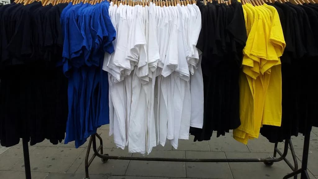 T shirts hanging on a clothes rail at a market stall