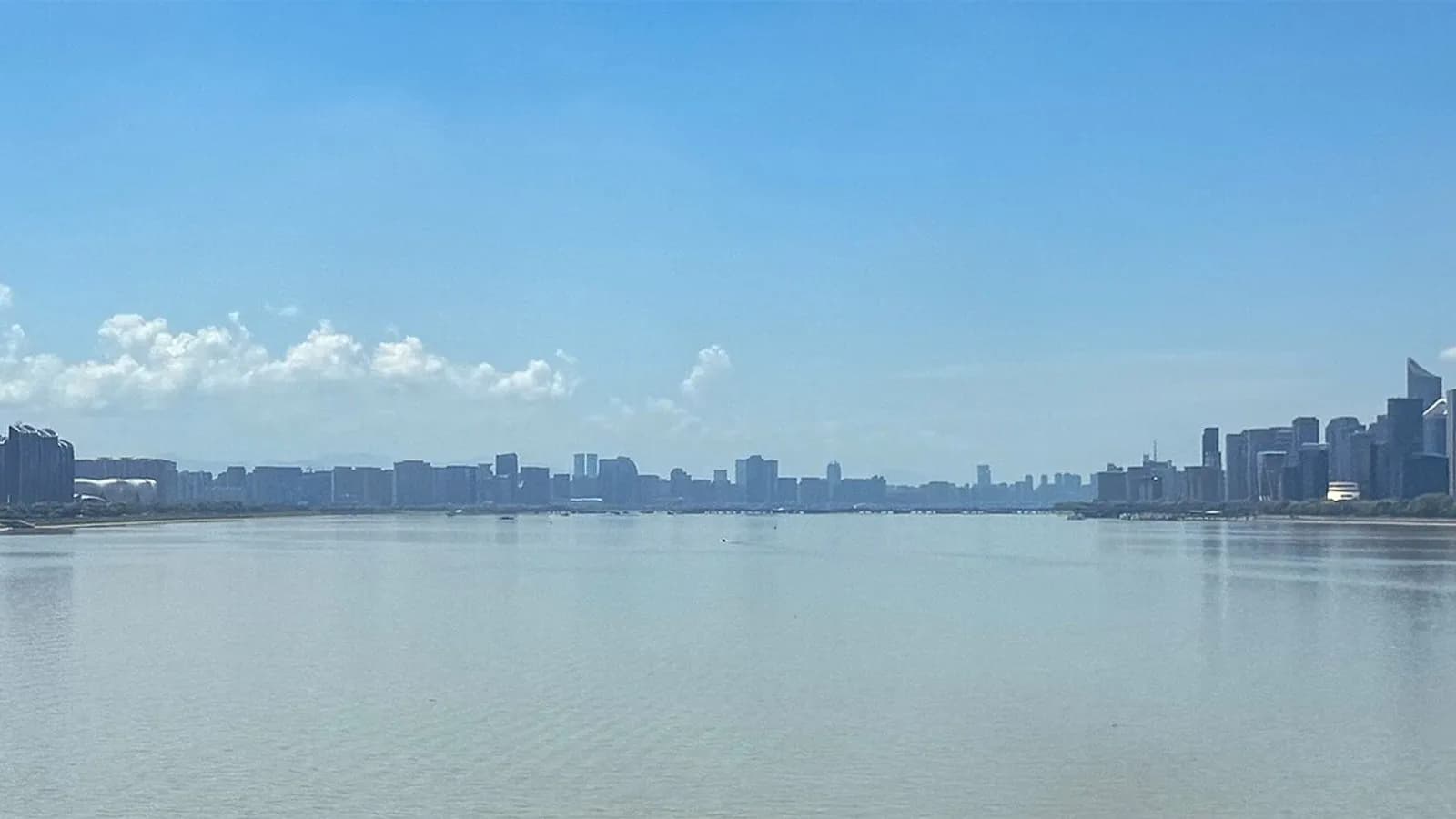 A wide view across the Qiantang River in Hangzhou, China, with the city skyline on the far bank under a blue sky, photographed on 2 August 2026, a file photograph of the city where DeepSeek is based and not of the safety tests