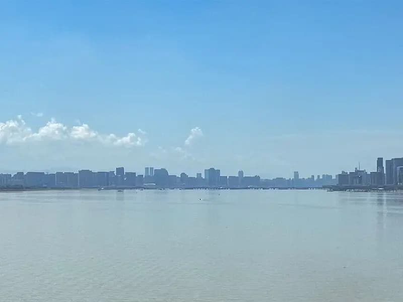 A wide view across the Qiantang River in Hangzhou, China, with the city skyline on the far bank under a blue sky, photographed on 2 August 2026, a file photograph of the city where DeepSeek is based and not of the safety tests