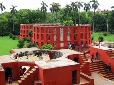 Red sandstone observatory instruments of the Jantar Mantar in New Delhi, with palm trees behind, photographed in July 2011, a file photograph of the site where the rally was planned and not of Saturday's lockdown or protest