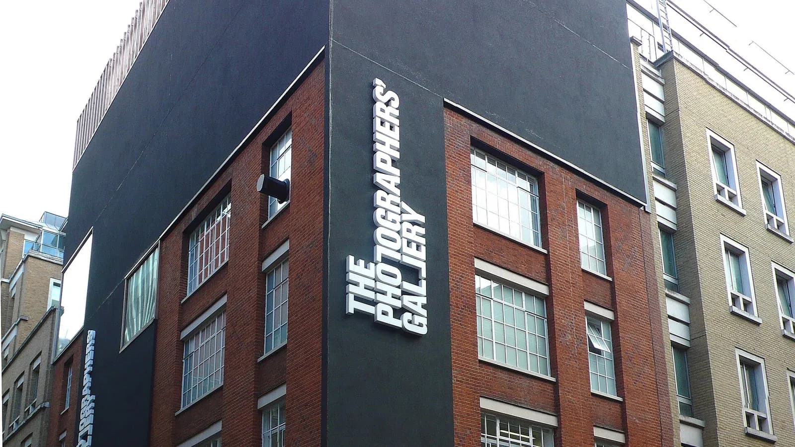 The dark upper facade and white lettering of The Photographers' Gallery on a brick street in Soho, London, photographed around 2013, a file photograph of the venue that will host the 2027 shortlist exhibition
