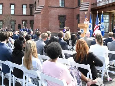 Guests seated outdoors in front of a brick building on the St. Elizabeths campus in Washington during the opening ceremony of the Department of Homeland Security's new headquarters, photographed on 10 April 2019, a file photograph of the department and not of this week's order