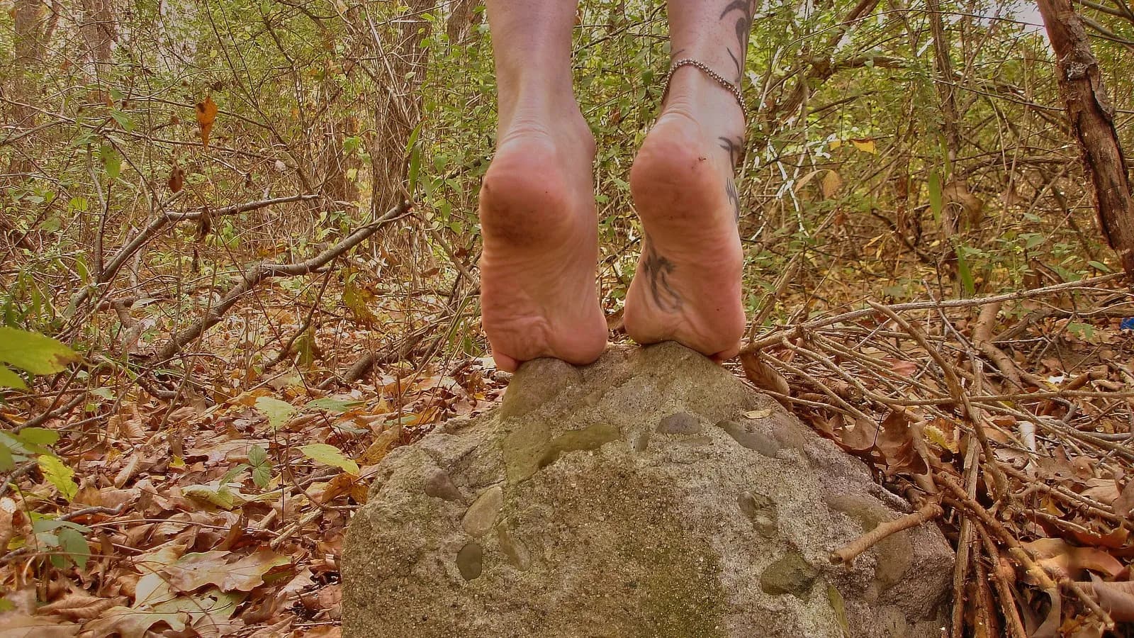 Bare feet standing on a rock