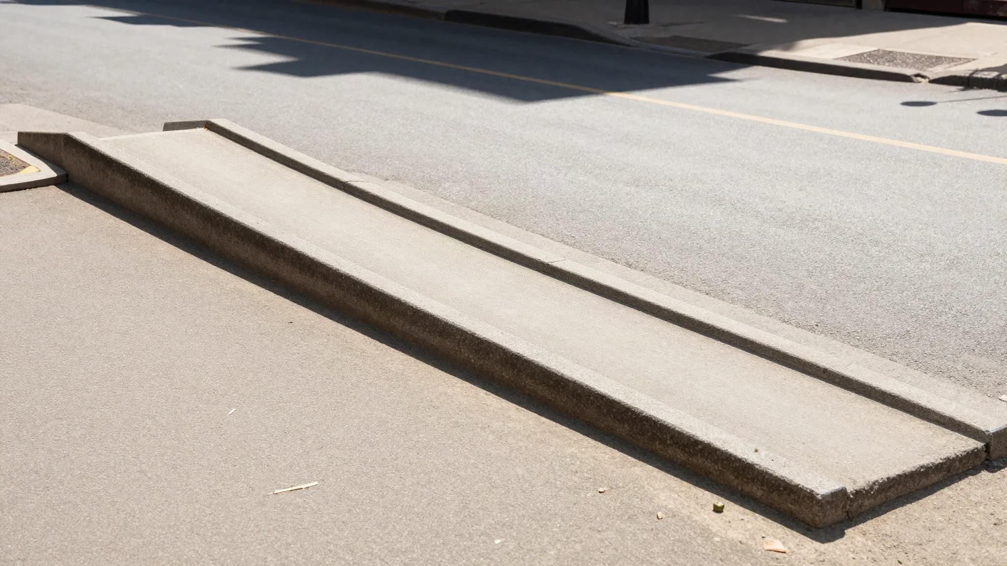 A wheelchair ramp on a city street in summer heat