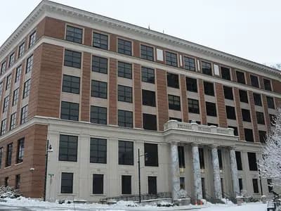 The Alaska State Capitol in Juneau, a multi-storey brick and stone building, with snow on the ground and trees, photographed on 3 January 2021, a file photograph of the state capitol and not of the courthouse or the lawsuit