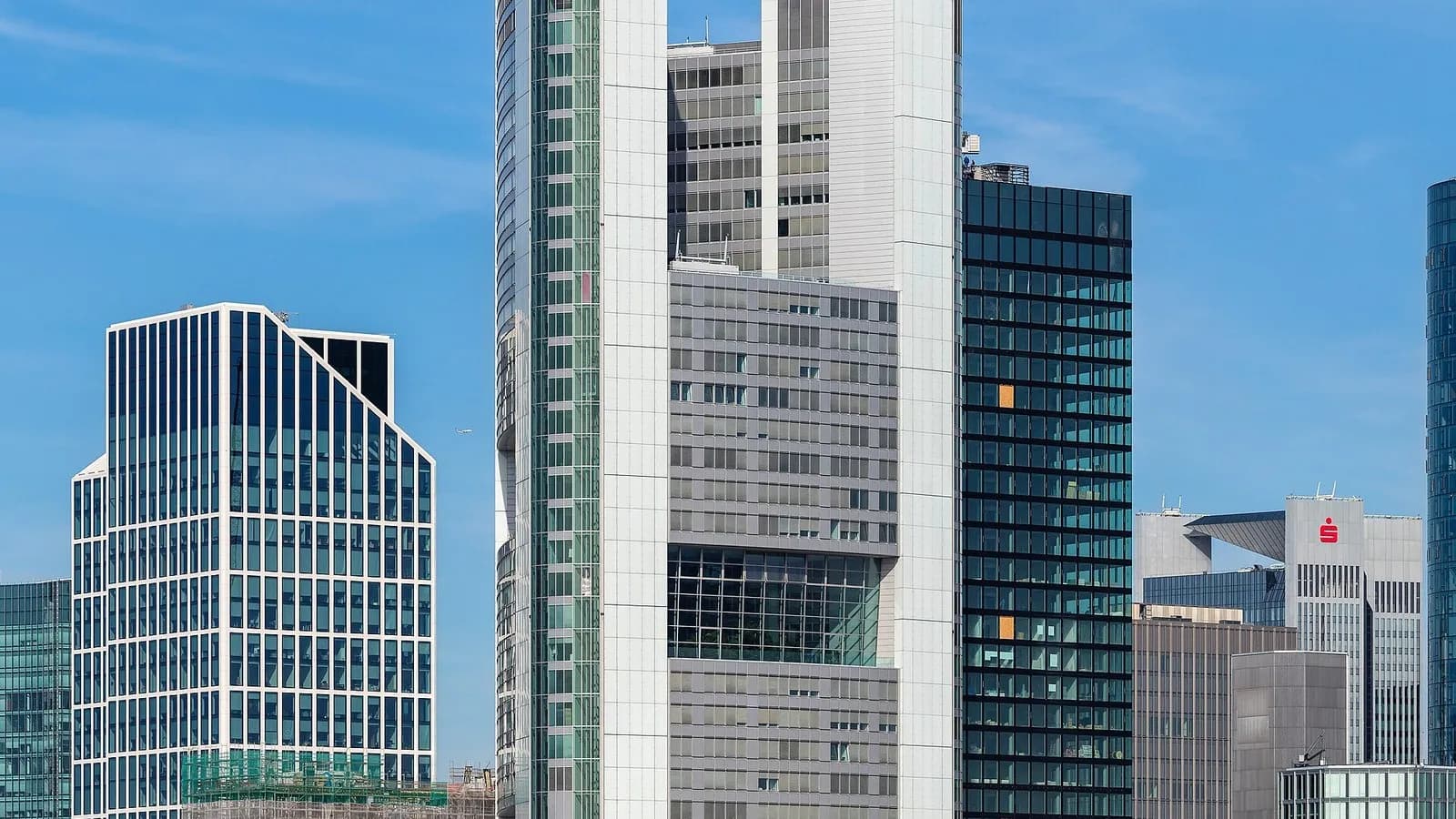The Commerzbank Tower in Frankfurt rising above neighbouring office buildings under a blue sky, photographed on 10 July 2019, a file photograph of the German bank's headquarters tower and not from this week