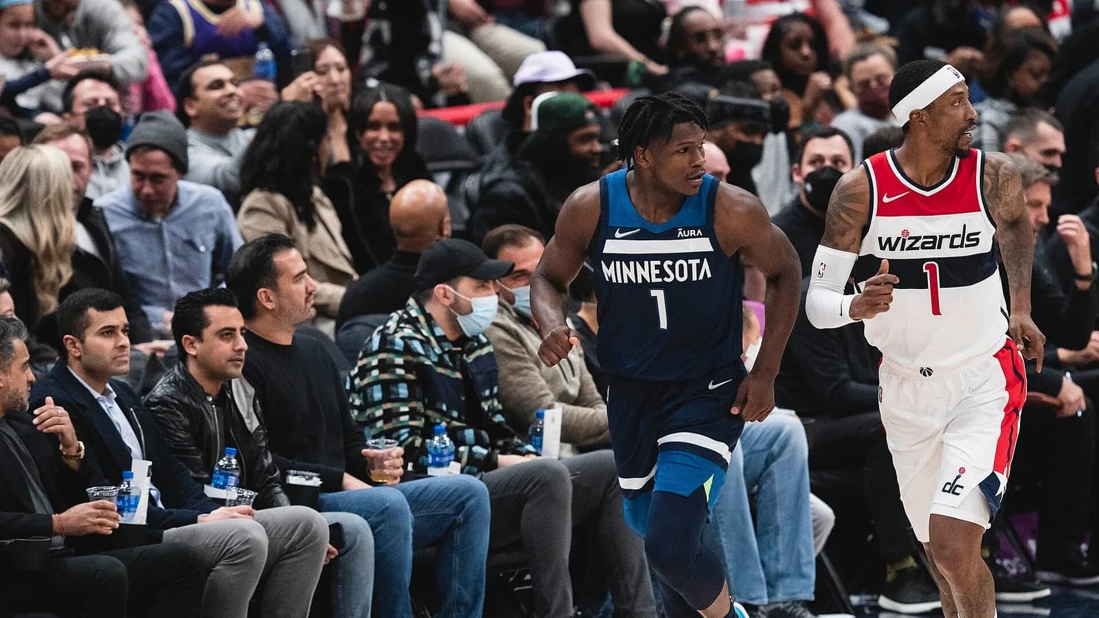 Anthony Edwards of the Minnesota Timberwolves, number 1 in a dark blue jersey, running up court beside a Washington Wizards player in front of courtside spectators, photographed on 1 December 2021, a file photograph of Edwards and not of his surgery or of Thursday night's games