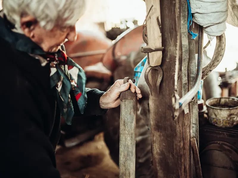 An older craftsperson at work in a traditional workshop