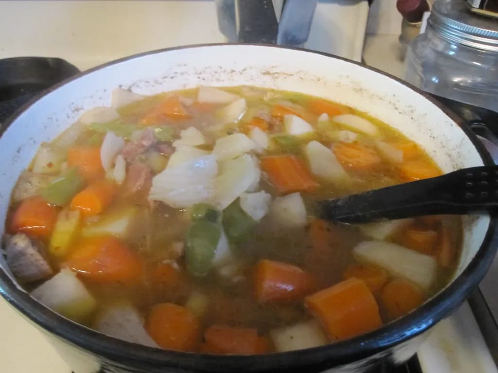 A spiced lamb and vegetable stew served over layers of thin bread