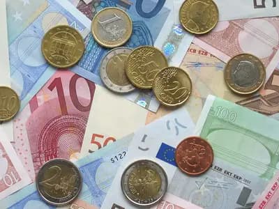 Euro banknotes and coins of several denominations spread on a table, photographed on 14 October 2006, a file photograph illustrative of the euro and not of any stablecoin or of ESMA