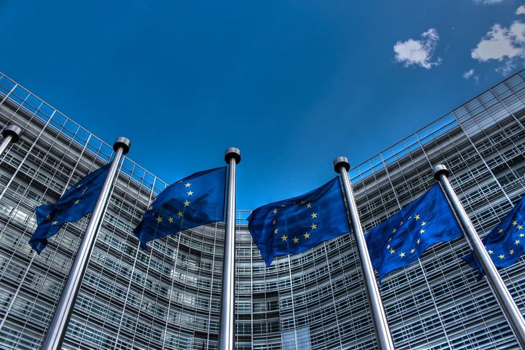 European Union flags outside a government building, representing the bloc's new crypto regulatory framework
