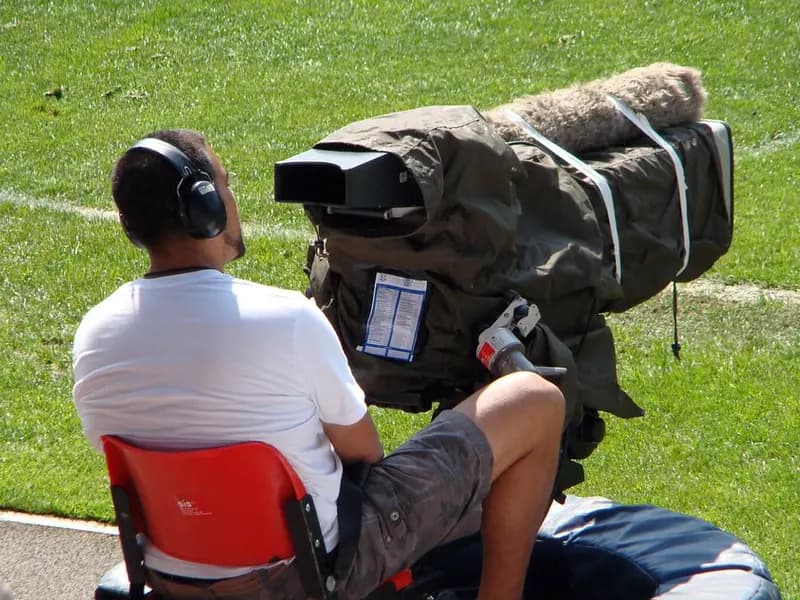 Broadcast cameras overlooking a major football stadium