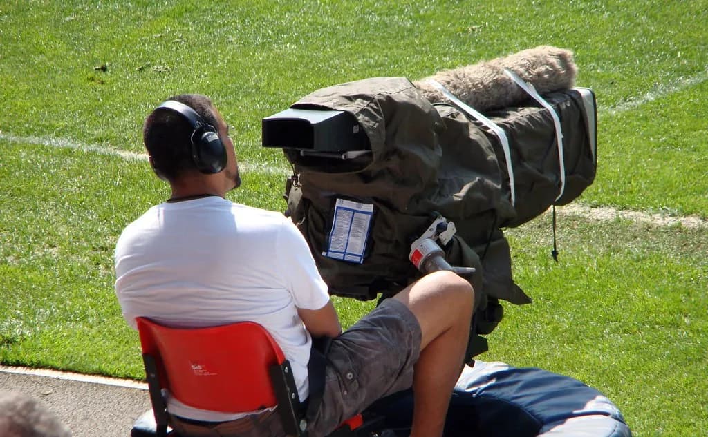 Broadcast cameras overlooking a major football stadium