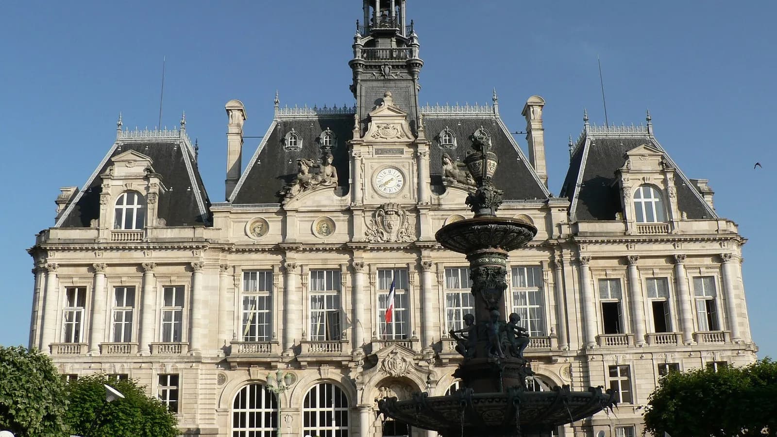 The ornate city hall of Limoges, France, with its clock tower and a fountain in front, seen under a blue sky and photographed on 10 June 2006, a file photograph of the building and not from Saturday's protests or the fire