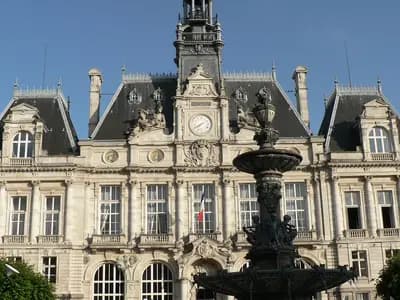 The ornate city hall of Limoges, France, with its clock tower and a fountain in front, seen under a blue sky and photographed on 10 June 2006, a file photograph of the building and not from Saturday's protests or the fire
