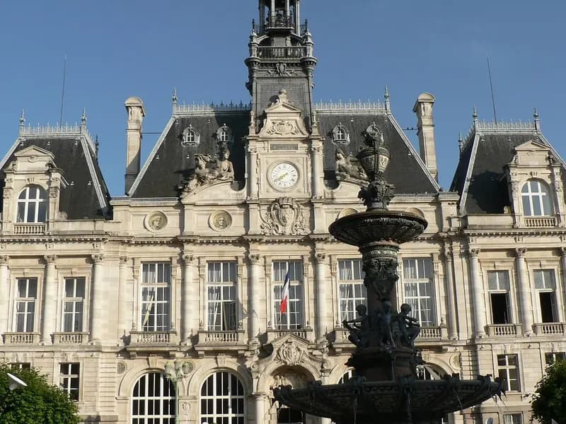 The ornate city hall of Limoges, France, with its clock tower and a fountain in front, seen under a blue sky and photographed on 10 June 2006, a file photograph of the building and not from Saturday's protests or the fire