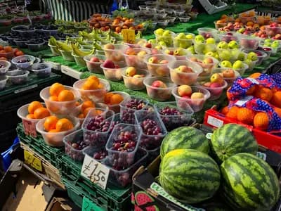 A market stall piled with oranges, peaches, grapes, apples and watermelons in the Market Place at Romford in London, photographed on 20 March 2026, a file photograph illustrative of fresh produce and not of the trial