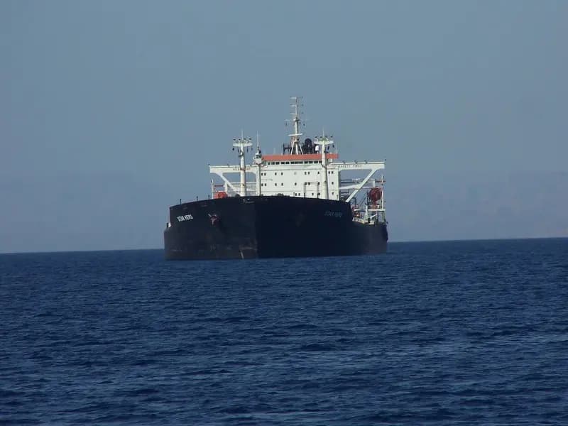 Commercial ships moving through Gulf waters near the Strait of Hormuz