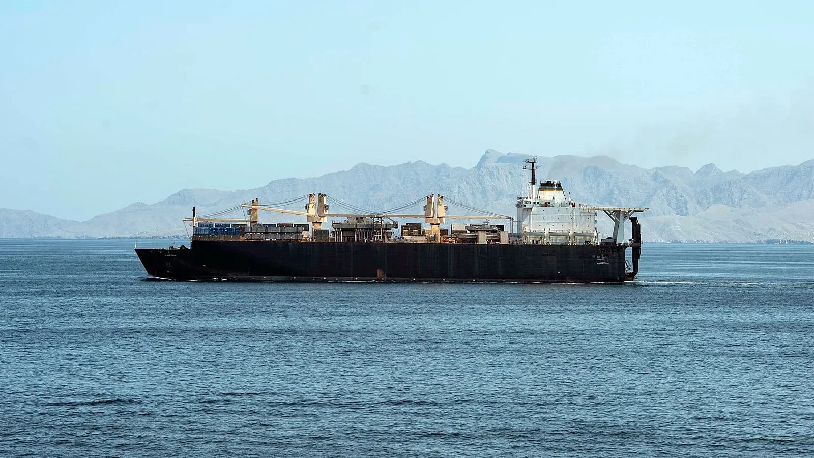 The US Navy dry cargo ship USNS PFC Dewayne T. Williams underway in the Strait of Hormuz with mountains behind it, photographed on 17 April 2020, a file photograph illustrative of merchant shipping in the strait and not of the GFS Pride or Cape Dao