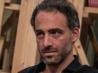 Raphael Glucksmann seated before wooden shelves, looking to one side, photographed in October 2017, a file photograph and not from the primary