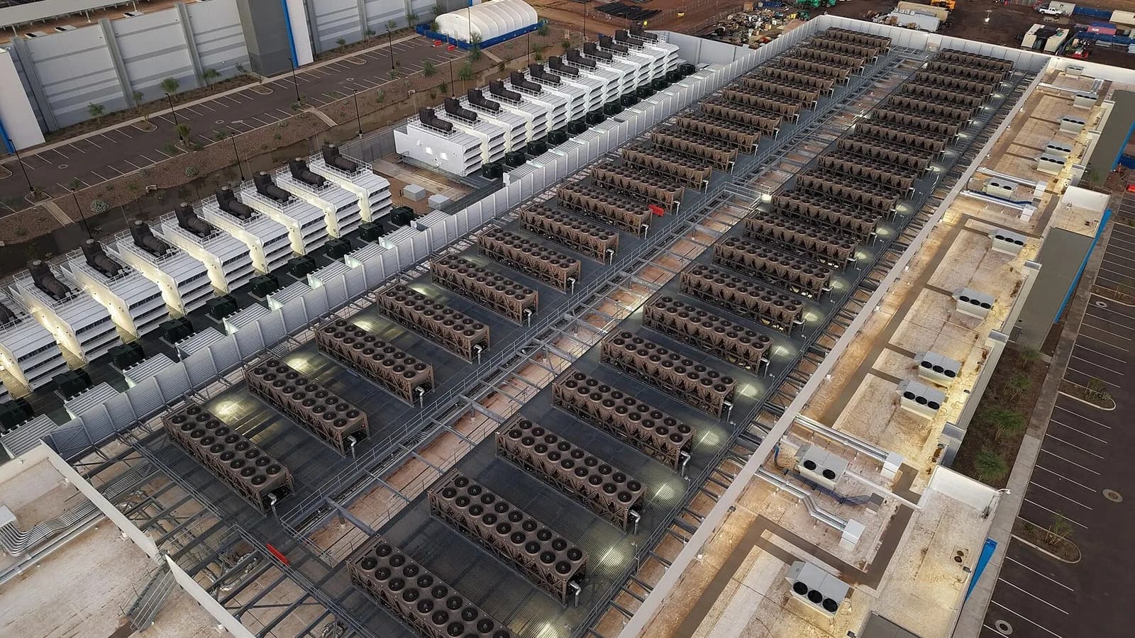 An aerial view of rows of rooftop cooling units on a large data centre at night-time lighting, photographed on 23 November 2025, a file photograph illustrative of data centres and not of Google's London zone