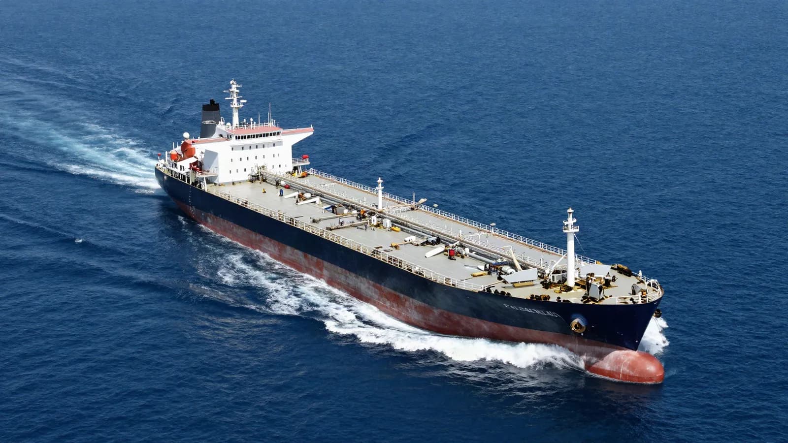 A loaded oil tanker under way on open blue water