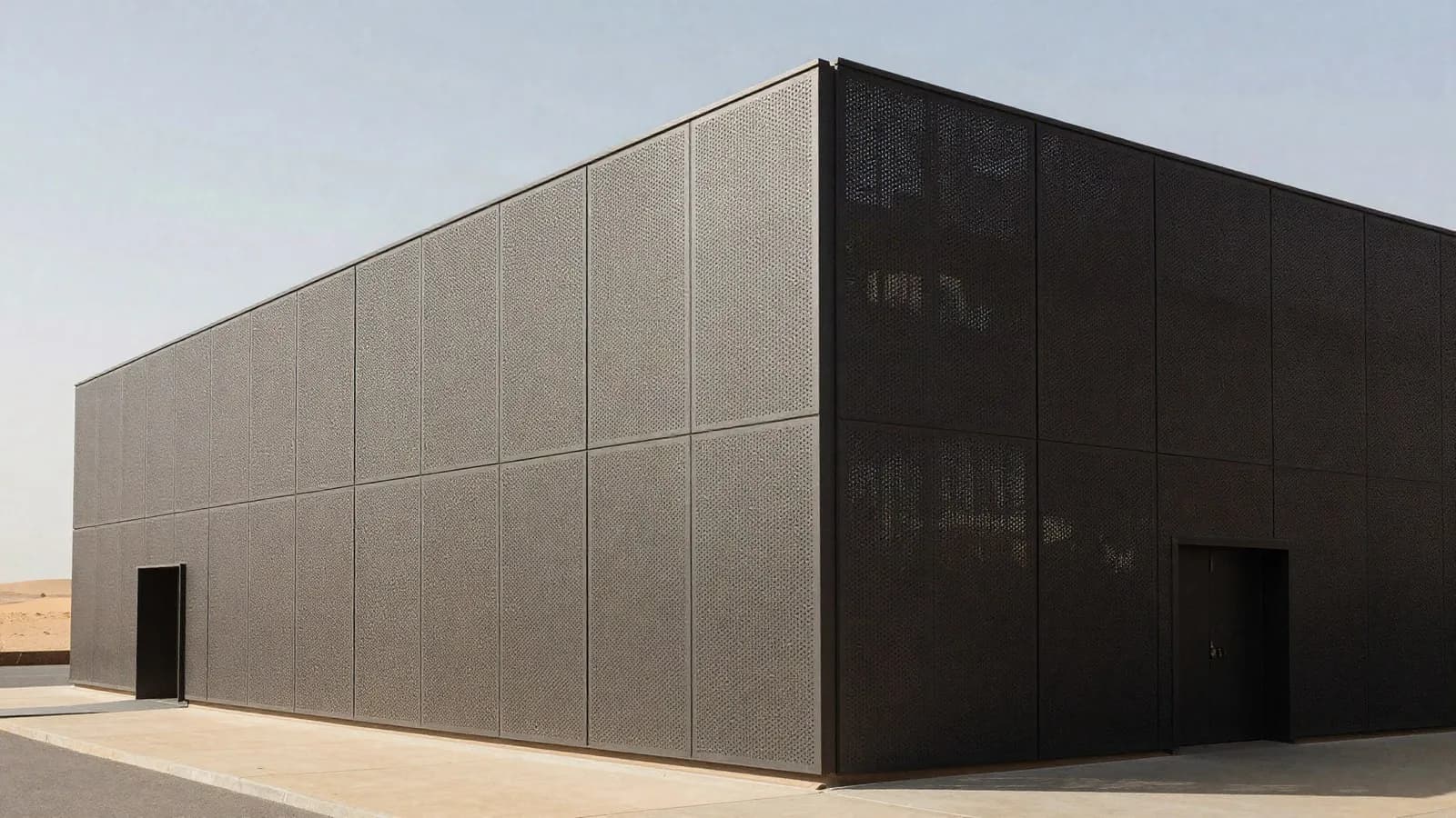 A deep perforated shading screen across the sunlit elevation of a modern building