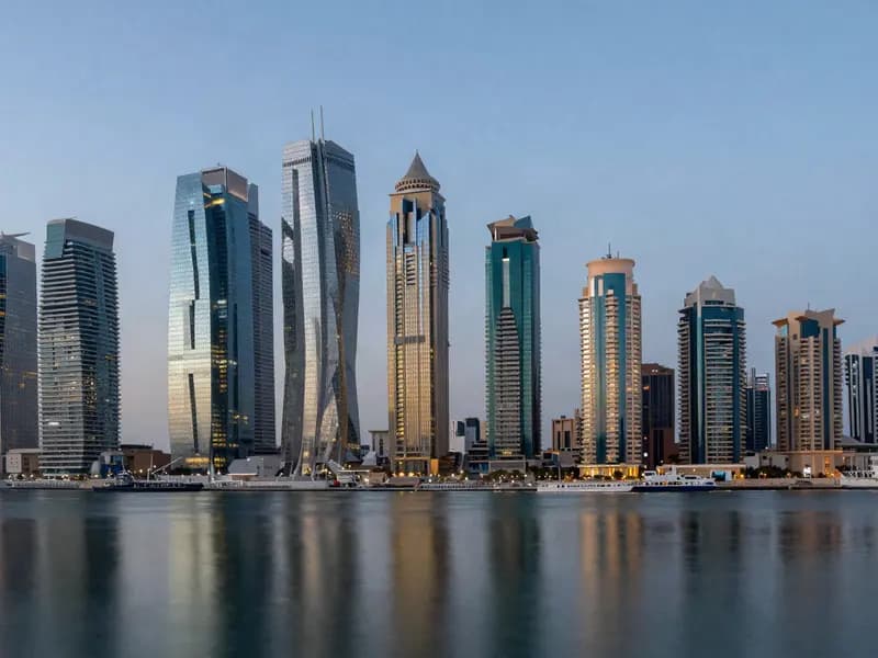A modern Gulf financial district skyline at dusk