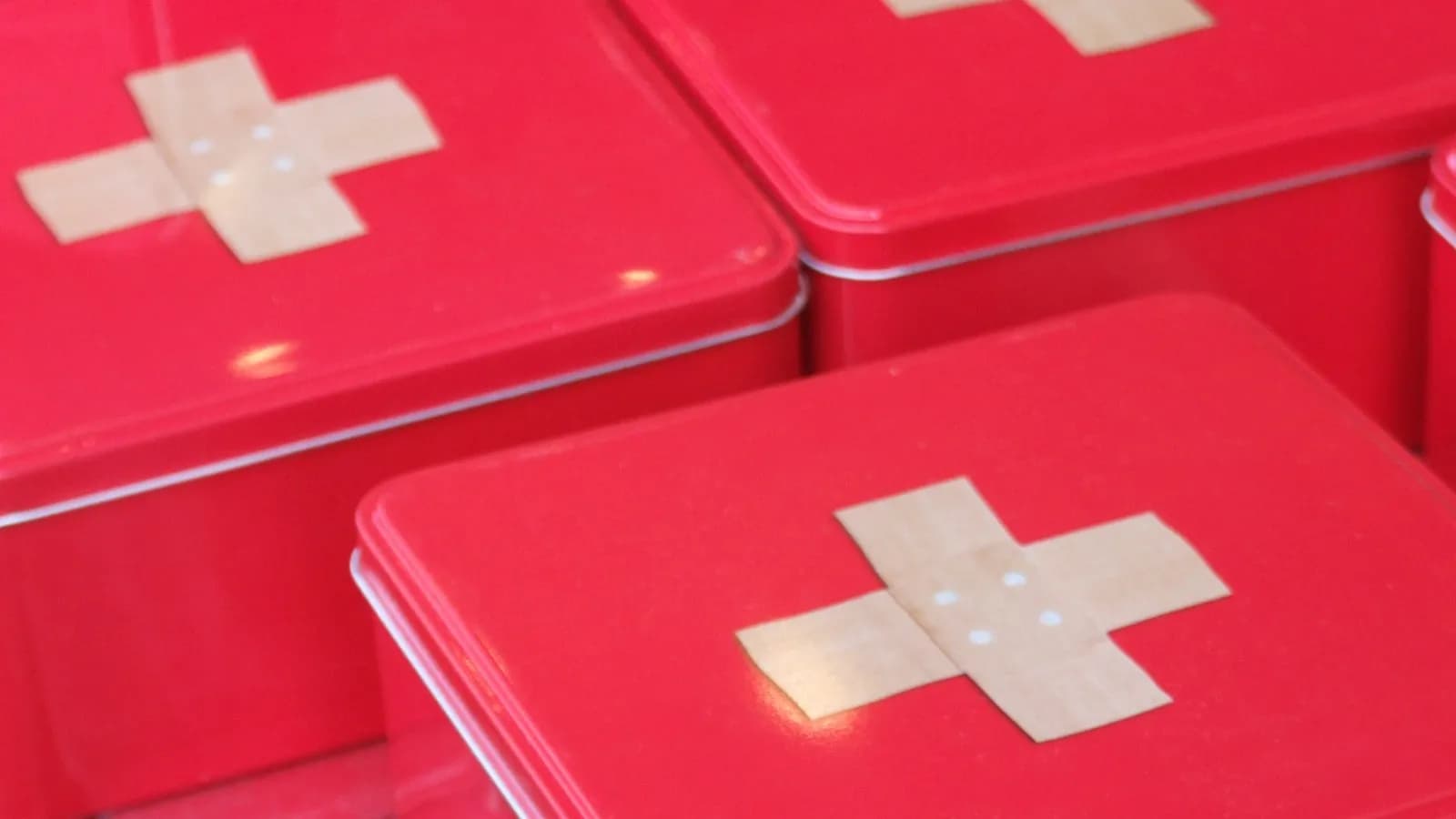 Red metal first aid tins marked with plaster crosses, a stand-in for a household kit and not a fully stocked one, photographed in January 2009