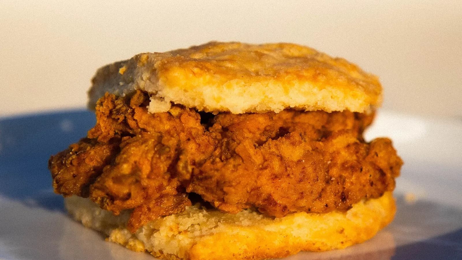 A fried chicken fillet in a split golden biscuit sandwich, photographed on 26 September 2023 at a restaurant in Taipei, Taiwan, a file photograph of a North Carolina style chicken biscuit and not of the Popeyes sandwich